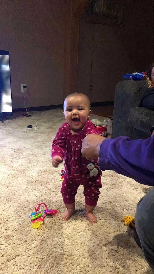 Melody is registered to the contest to win money with this photo: adaptation, baby, baby_toddler_clothing, child, facial_expression, flooring, foot, fun, gesture, happy, leg, morning, mouth, person, play, sitting, skin, thumb, toddler, toy