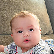 Victor joined the competition — help win amazing prizes! baby, infant, child, face, eyes, cheeks, mouth, stripe_shirt, clothing, blanket, couch, pillow, hand, indoor, soft_light, portrait, cute, gaze, hair, cozy