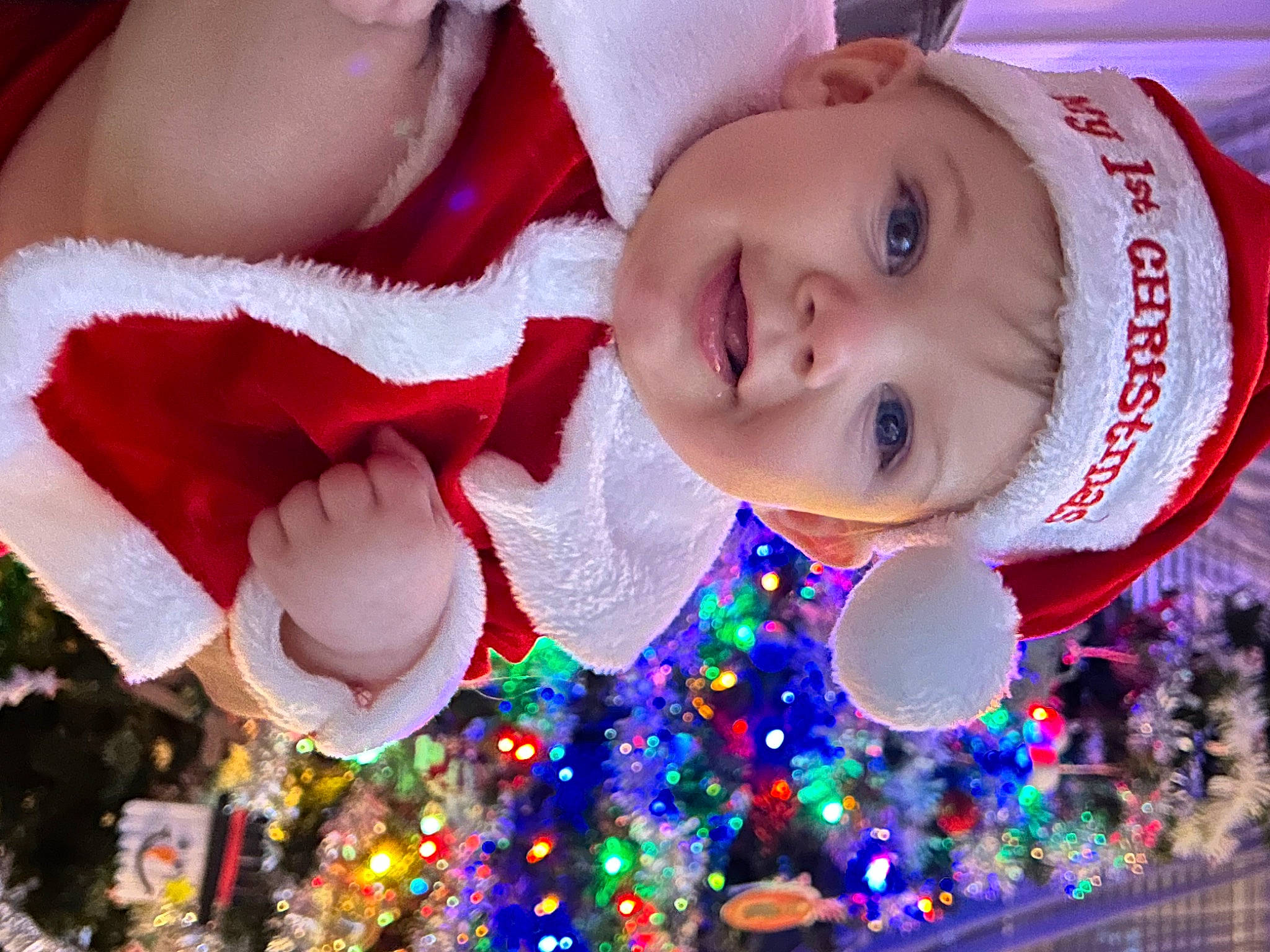 Noah is registered to the contest to win money with this photo: baby_toddler_clothing, child, christmas, christmas_decoration, christmas_eve, christmas_ornament, christmas_tree, event, fun, happy, hat, headwear, holiday, holiday_ornament, joy, light, ornament, party_supply, person, pink