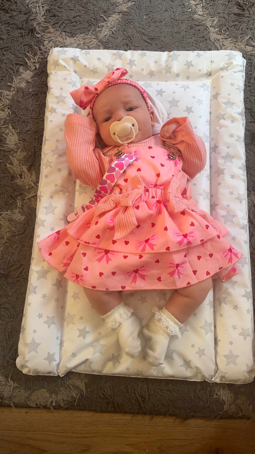 Nevaeh-Joan joined the competition — help win amazing prizes! baby, infant, pacifier, pink_dress, headband, socks, cushion, star_pattern, carpet, floor, child, lying_down, cute, indoor, soft_toys, clothing, baby_girl, sleeping_mat, comfortable, adorable