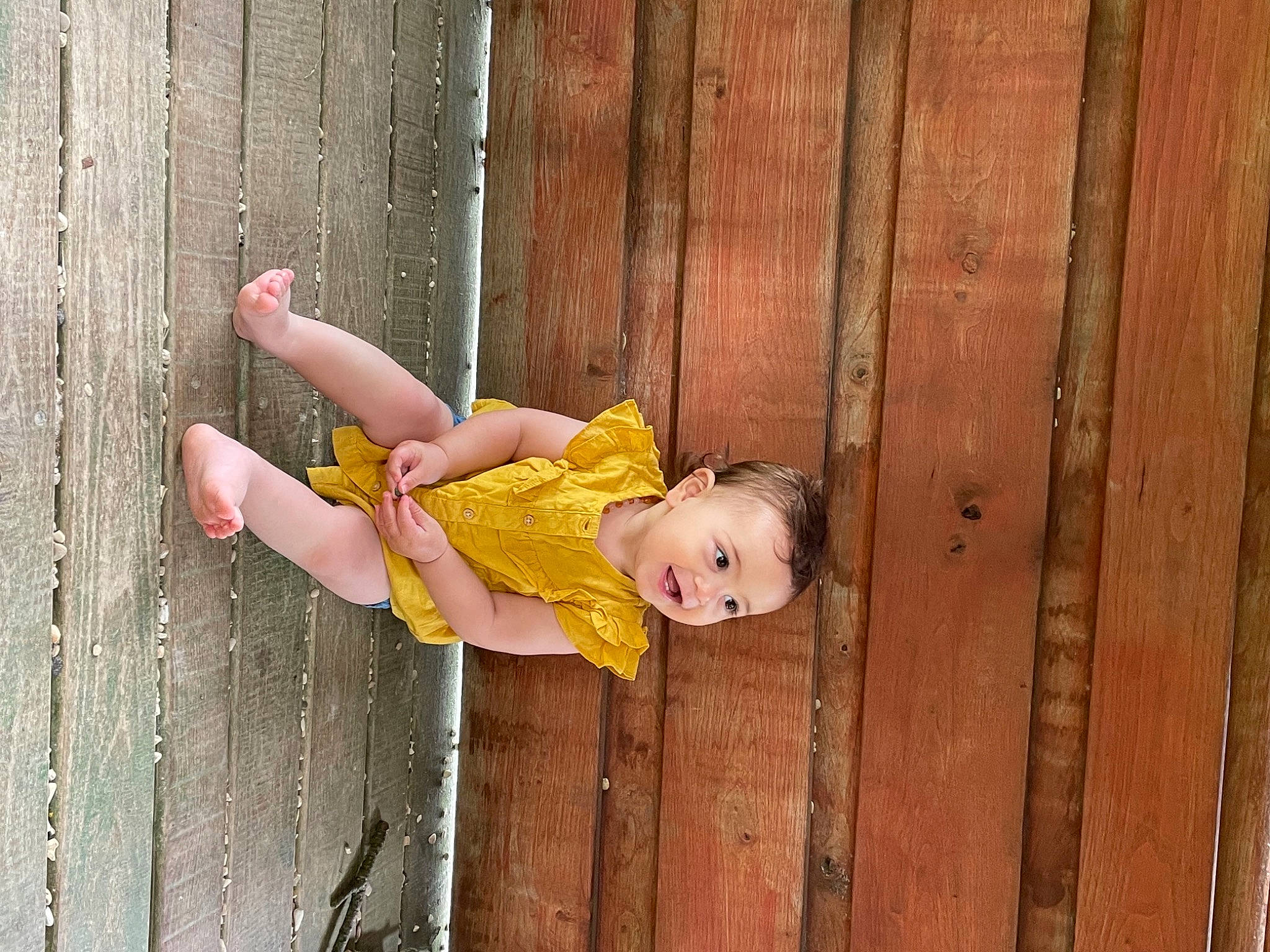 Thëa a rejoint le concours — aidez-le/la à gagner de superbes lots ! baby, baby_products, baby_toddler_clothing, child, eye, grass, happy, hardwood, human_leg, leg, leisure, magenta, people_in_nature, person, sandal, sitting, smile, thigh, toddler, wood