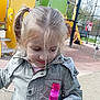 Celia participe au concours pour gagner de l'argent avec cette photo : child, girl, playground, bottle, blonde_hair, pony_tail, jacket, outdoor, toy, play_equipment, slide, rope_climbing, daylight, park, smile, casual_clothing, young, curly_hair_strands, happy, nature