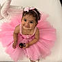 toddler, child, pink_tutu, headband, smiling, toy, indoor, couch, cute, portrait, dress, baby, sitting, footwear, happy, girl, curly_hair, playful, accessory, young_child