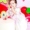 Ailany Hernández joined the competition — help win amazing prizes! toddler, child, strawberry, dress, bow, balloons, birthday, cute, smiling, indoor, decor, party, props, white_dress, pink_bow, barefoot, curly_hair, colorful, celebration, portrait