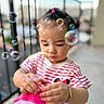 balcony, bracelet, bubbles, child, colorful, curious, cute, daylight, focus, outdoor, person, pigtails, play, portrait, railing, small_hands, striped_shirt, toddler, toy, young_child