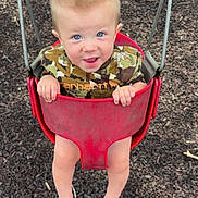 James joined the competition — help win amazing prizes! toddler, child, swing, playground, red_swing, blue_eyes, barefoot, smiling, tongue_out, short_hair, mohawk, outdoor, play, fun, young_child, person, seat, ground, metal_chains, casual_clothing