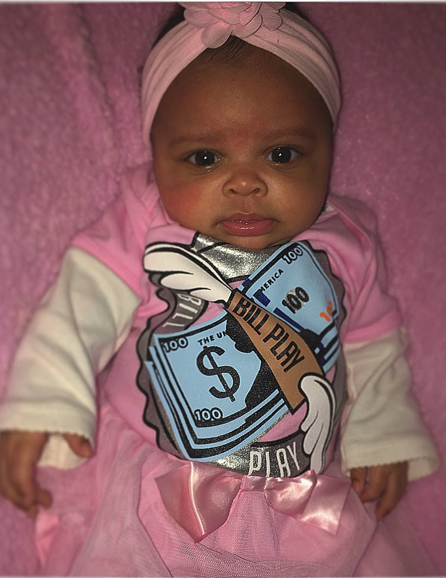 Rosie is registered to the contest to win money with this photo: baby, cheek, child, cool, forehead, hoodie, outerwear, person, pink, product, sleeve, smile, toddler