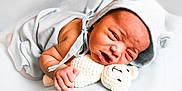 Jakhari joined the competition — help win amazing prizes! newborn, baby, infant, blue, hood, bear_ears, crocheted_toy, teddy_bear, blanket, soft, cute, sleepy, face, hand, clothing, lying_down, portrait, child, cozy, expression