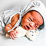 newborn, baby, infant, blue, hood, bear_ears, crocheted_toy, teddy_bear, blanket, soft, cute, sleepy, face, hand, clothing, lying_down, portrait, child, cozy, expression