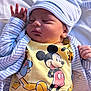 newborn, baby, sleeping, mickey_mouse, yellow_clothing, striped_hat, striped_jacket, infant, cute, soft, peaceful, portrait, child, clothing, cartoon_character, lying_down, indoors, resting, hat, cute_outfit