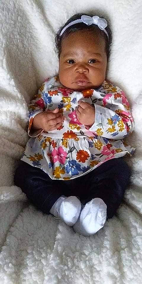 Zola Kimberlynn is registered to the contest to win money with this photo: baby, baby_products, baby_toddler_clothing, cheek, child, chin, comfort, eye, hairstyle, happy, head, iris, lip, mouth, nose, person, sitting, skin, sleeve, textile