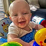 baby, smiling, happy, child, toys, colorful, indoor, infant, face, closeup, playtime, cute, bright, cheerful, person, young, skin, expression, seat, daylight