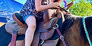 Lana is registered to the contest to win money with this photo: child, horse, saddle, barefoot, outdoor, blue_sky, greenery, leather, reins, shorts, tank_top, purple_hair_streak, necklace, animal, pet, summer, sunlight, nature, portrait, cute