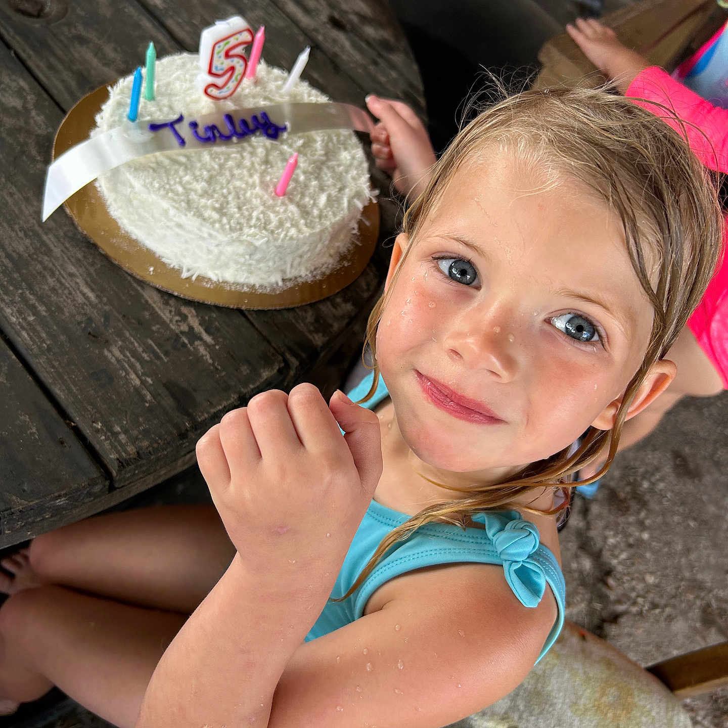 Tinley joined the competition — help win amazing prizes! birthday, blue_eyes, cake, candles, celebration, child, clothing, fun, happy, indoors, number_five, party, person, rustic, sitting, smiling, summer, table, wet_hair, wood