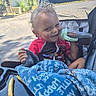 Cain joined the competition — help win amazing prizes! baby_clothes, blanket, cheeky, child, curly_hair, daytime, face, food, fries, greenery, hand, outdoor, person, playful, seat, sippy_cup, smiling, stroller, sunny, toddler