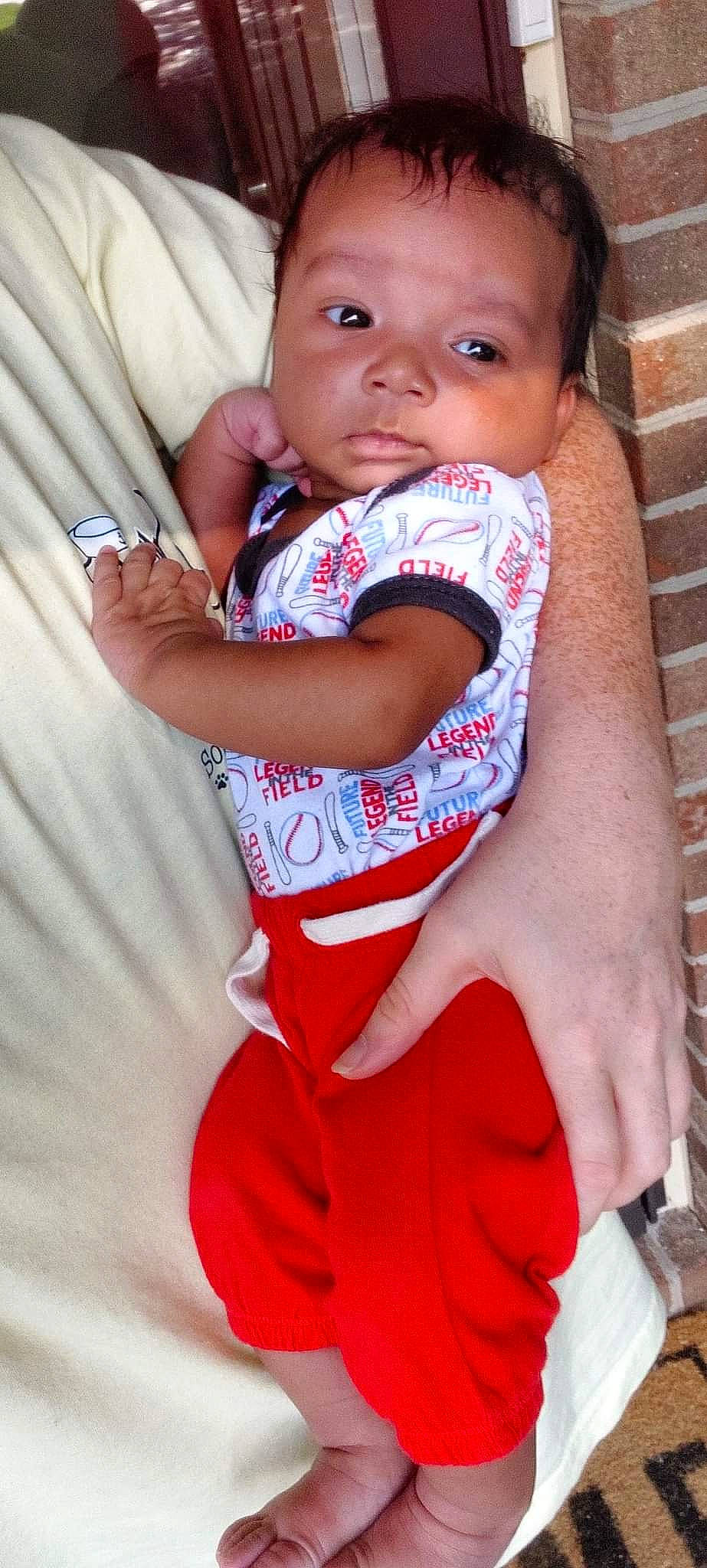 Karter is registered to the contest to win money with this photo: arm, baby, baby_toddler_clothing, cheek, child, eye, eyelash, face, finger, gesture, hand, happy, head, iris, lip, nose, person, pink, skin, sleeve