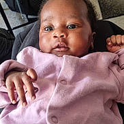 Evanna is registered to the contest to win money with this photo: baby, infant, pink_clothing, face, hand, indoor, carpet, bag, person, cute, portrait, child, young, cozy, casual, curious, bright_eyes, soft_texture, sitting, relaxed