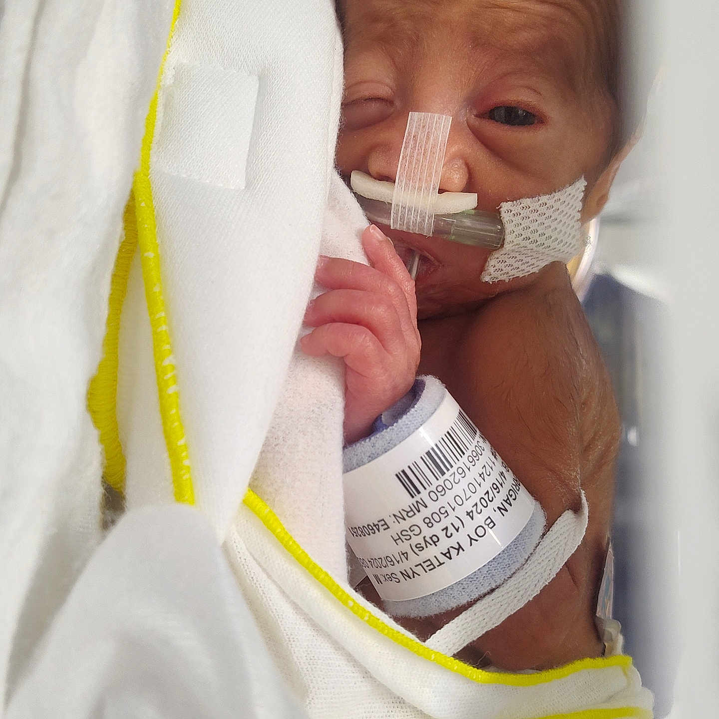 Landon is registered to the contest to win money with this photo: architecture, baby, blanket, bodypart, bottle, building, clinic, clothing, face, finger, furniture, glove, hand, head, hospital, newborn, person, photography, portrait, towel