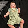 arms, baby, bed, black_background, blanket, child, clothing, cute, expression, face, indoor, infant, legs, lying_down, overalls, pacifier, person, skin, soft_lighting, young_child