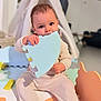 baby, blue, child, colorful, cozy, curious, face, floor, foam_mat, hand, indoor, onesie, orange, playtime, puzzle_piece, seated, soft, tent, toy, white
