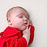 baby, blanket, child, closeup, cozy, cute, face, hand, head, indoors, infant, newborn, peaceful, portrait, red_clothing, resting, skin, sleeping, soft, toddler
