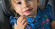 Dylani joined the competition — help win amazing prizes! apparel, blue_dress, button, car_seat, child, cute, embroidery, fabric, face, girl, hair, hand, indoor, person, portrait, seatbelt, sitting, smile, toddler, young_child