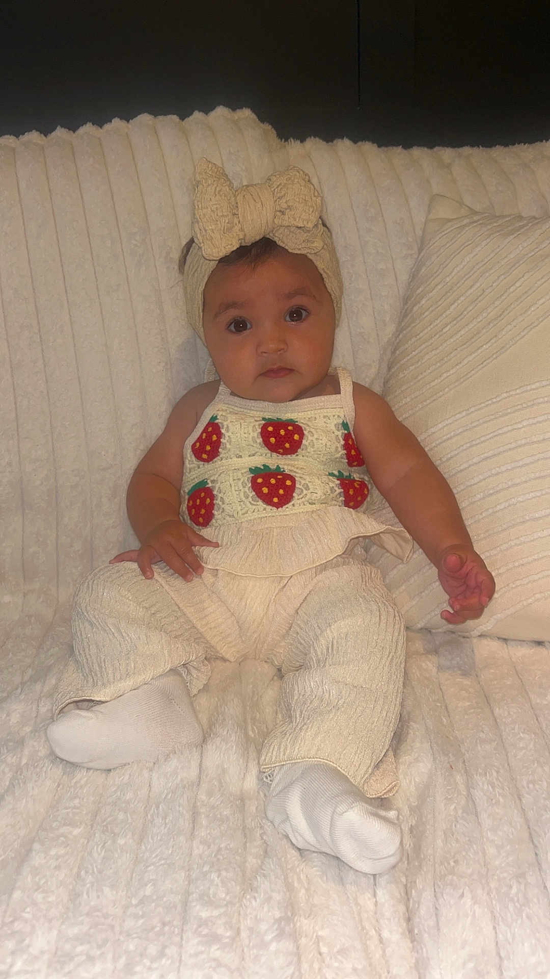 Romie joined the competition — help win amazing prizes! baby, child, headband, bow, strawberry, top, pants, socks, blanket, pillow, texture, indoor, cozy, cute, sitting, portrait, clothing, person, infant, soft
