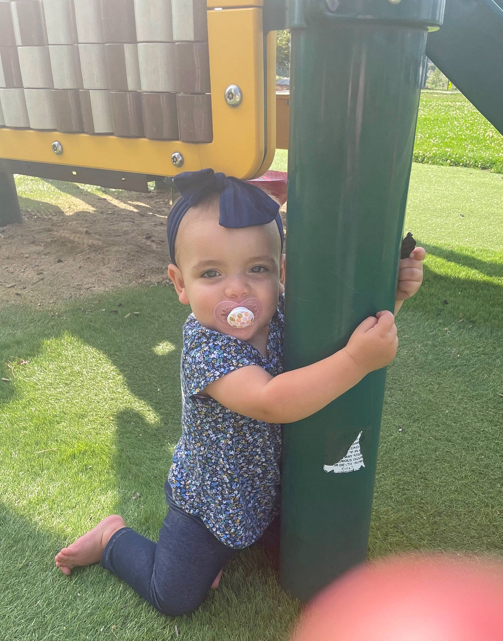 Presley joined the competition — help win amazing prizes! baby, baby_toddler_clothing, child, city, elbow, fun, grass, happy, human_leg, knee, leisure, outdoor_play_equipment, people_in_nature, person, play, playground, recreation, sitting, smile, thigh