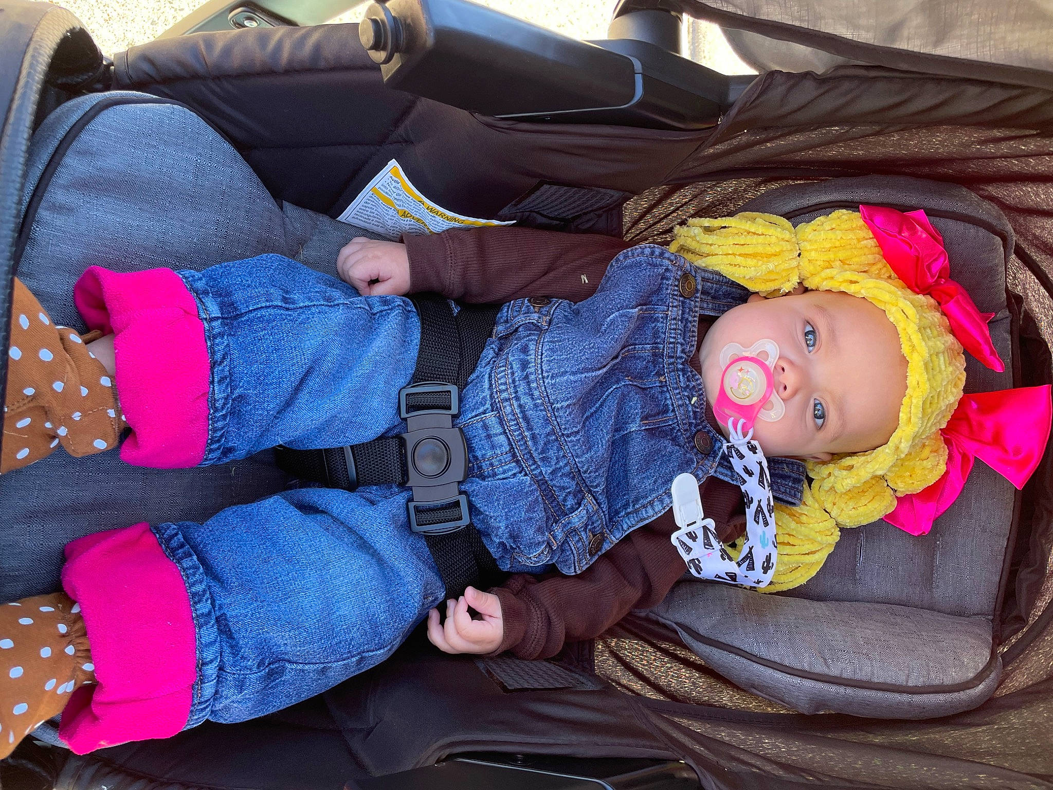 Presley is registered to the contest to win money with this photo: baby, baby_carriage, baby_products, baby_toddler_clothing, bag, car_seat, child, comfort, doll, electric_blue, headwear, lap, magenta, nap, pattern, person, purple, sitting, sleep, textile