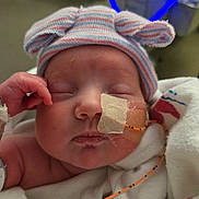 Rubi joined the competition — help win amazing prizes! newborn, baby, sleeping, hospital, feeding_tube, medical_tape, striped_hat, blanket, swaddle, closeup, face, cheek, hand, onesie, infant, soft_lighting, hospital_equipment, nasal_tube, cute, bed