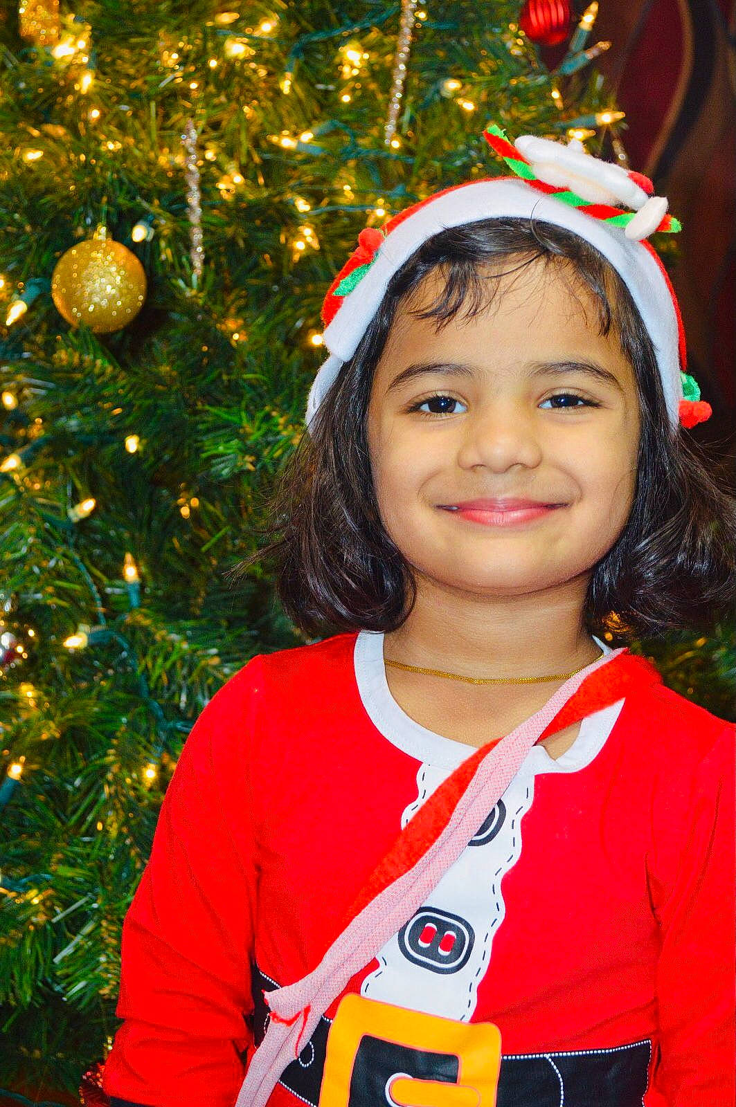 Aariana joined the competition — help win amazing prizes! beauty, child, christmas_ornament, christmas_tree, event, evergreen, face, facial_expression, fun, grass, happy, holiday_ornament, iris, joy, ornament, people_in_nature, person, plant, smile, sports_uniform