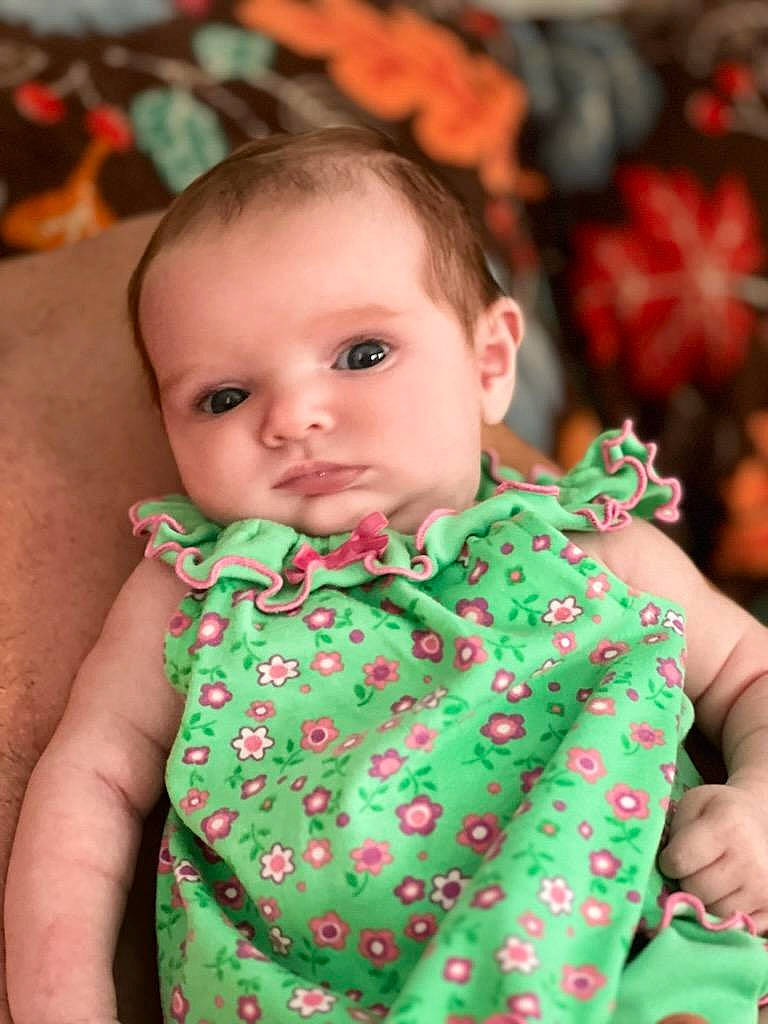 Chloe joined the competition — help win amazing prizes! baby_toddler_clothing, cheek, chin, dress, eye, face, facial_expression, hair, hairstyle, hand, happy, head, human, leaf, orange, organ, person, skin, sleeve, standing