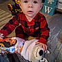 Grace is registered to the contest to win money with this photo: toddler, child, plaid_pajamas, stuffed_animal, toy_truck, carpet, indoor, floor, baby, hand, face, expression, furniture, block_letters, snow, playtime, cute, cozy, home, childhood