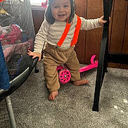 Jeremy Arroyo joined the competition — help win amazing prizes! toddler, child, standing, smiling, portrait, indoors, suspenders, striped_shirt, brown_pants, barefoot, pink_scooter, furniture, desk, carpet, window, playroom, trampoline, happy, young_child, home
