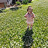 bench, child, cup, daisies, daylight, flower_field, garden, grass, greenery, happy, house, nature, outdoor, pink_jacket, portrait, shadow, small_child, sunlight, toddler, tree