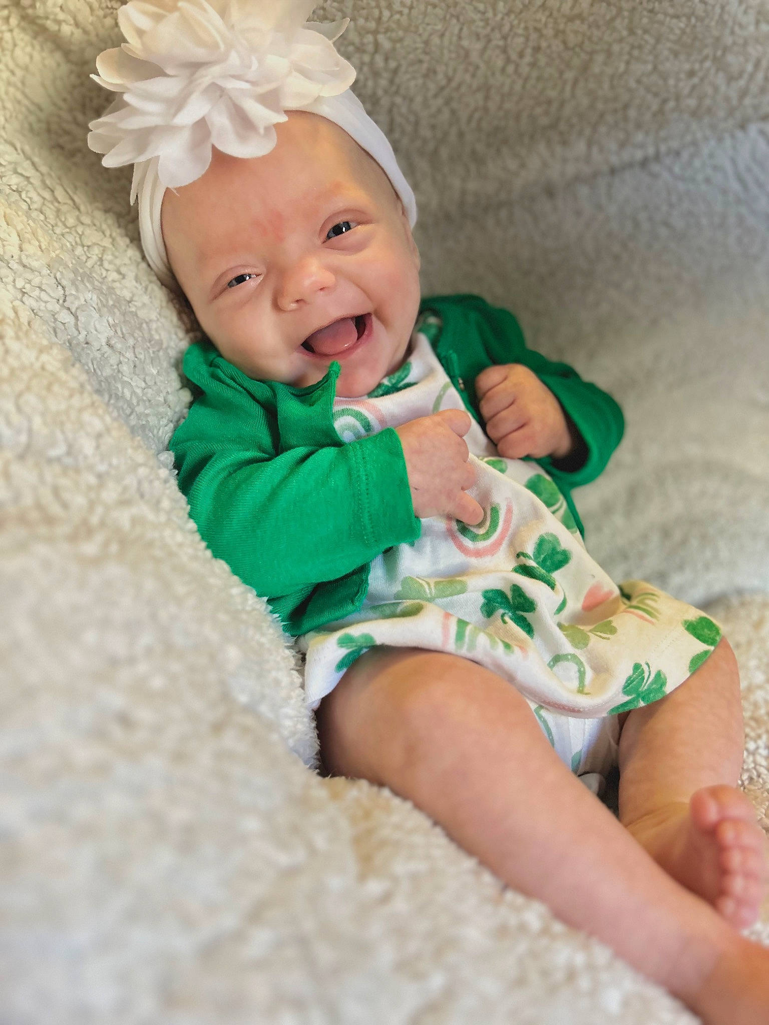Amira is registered to the contest to win money with this photo: baby, baby_toddler_clothing, child, comfort, dress, flower, grass, happy, headband, iris, leaf, linens, pattern, person, pink, skin, sleeve, smile, textile, thigh