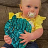 baby, brown_couch, casual_clothing, child, comfortable, couch, cute, denim_shorts, holding, indoor, infant, leaf_shaped_toy, pacifier, plush_toy, portrait, shorts, sitting, soft_toy, toddler, yellow_shirt