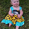 baby, child, grass, greenery, dress, sunflower_pattern, blue, outdoor, nature, sitting, smiling, barefoot, cute, infant, young_child, summer, happy, portrait, person, skin
