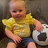 baby, balloon, celebration, chicken_print, child, couch, cow_print, cute, denim_shorts, foot, hand, happy, indoor, infant, party_hat, pom_pom, sitting, smiling, tongue_out, yellow_shirt
