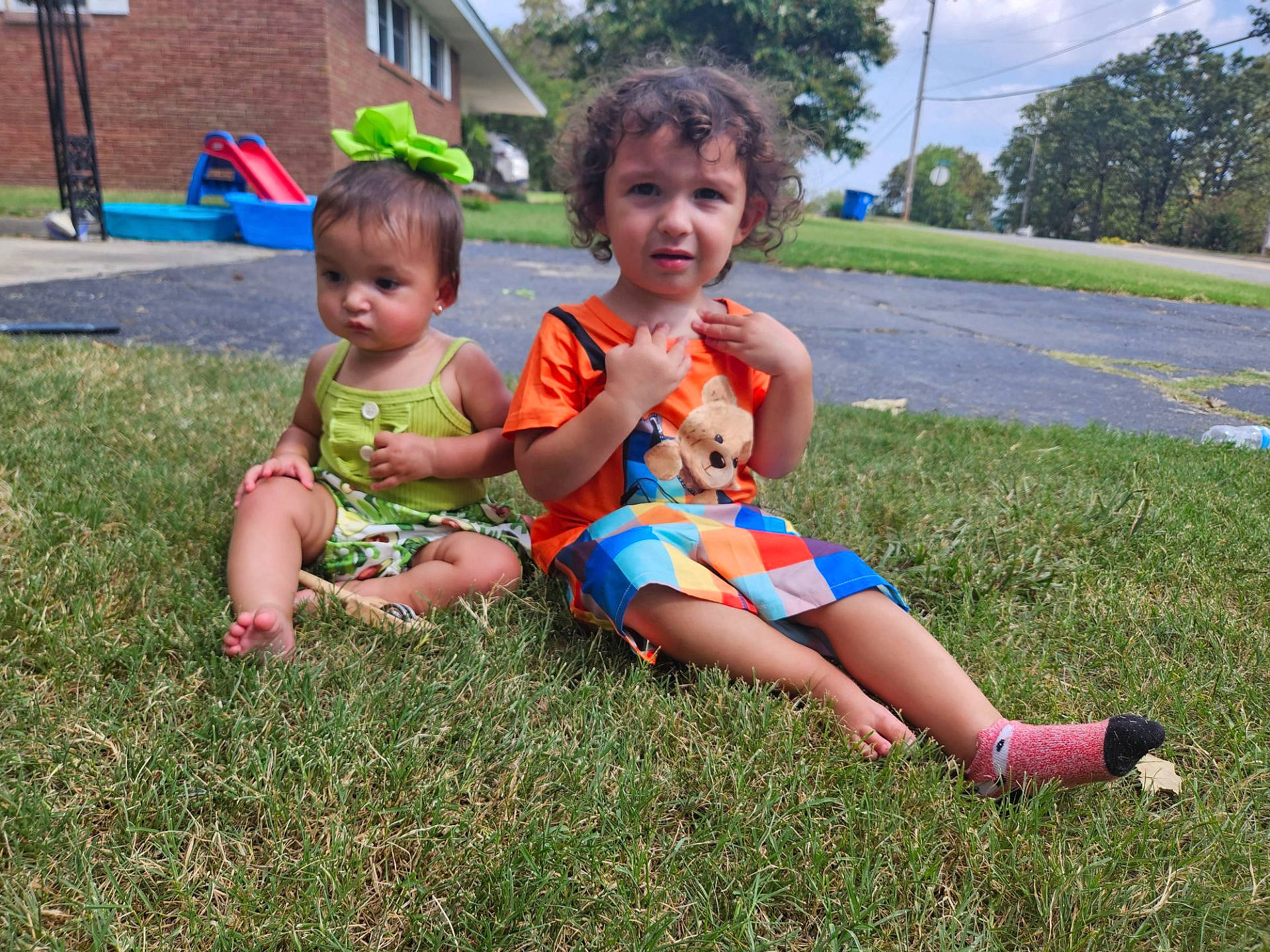 Yuna is registered to the contest to win money with this photo: baby, baby_toddler_clothing, child, cloud, event, face, fun, grass, grass_family, happy, lawn, leisure, people_in_nature, person, plant, recreation, shorts, sky, toddler, toy