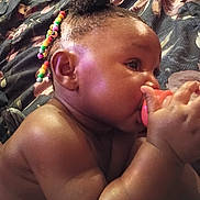 Zadie is registered to the contest to win money with this photo: baby, child, pacifier, beads, hair, skin, hand, face, ear, blanket, floral, comfort, closeup, cute, infant, portrait, lying_down, indoors, colorful, soft
