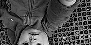 Salomé participe au concours pour gagner de l'argent avec cette photo : child, baby, face, hand, curious, black_and_white, portrait, texture, outdoor, clothing, zipper, young, person, closeup, expression, head, grass, pattern, sleeve, casual