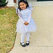 Victoria Huerta is registered to the contest to win money with this photo: child, girl, angel_costume, white_dress, halo, tights, black_shoes, sidewalk, grass, smiling, long_hair, pose, outdoor, daylight, costume, cute, portrait, holiday, happy, fashion