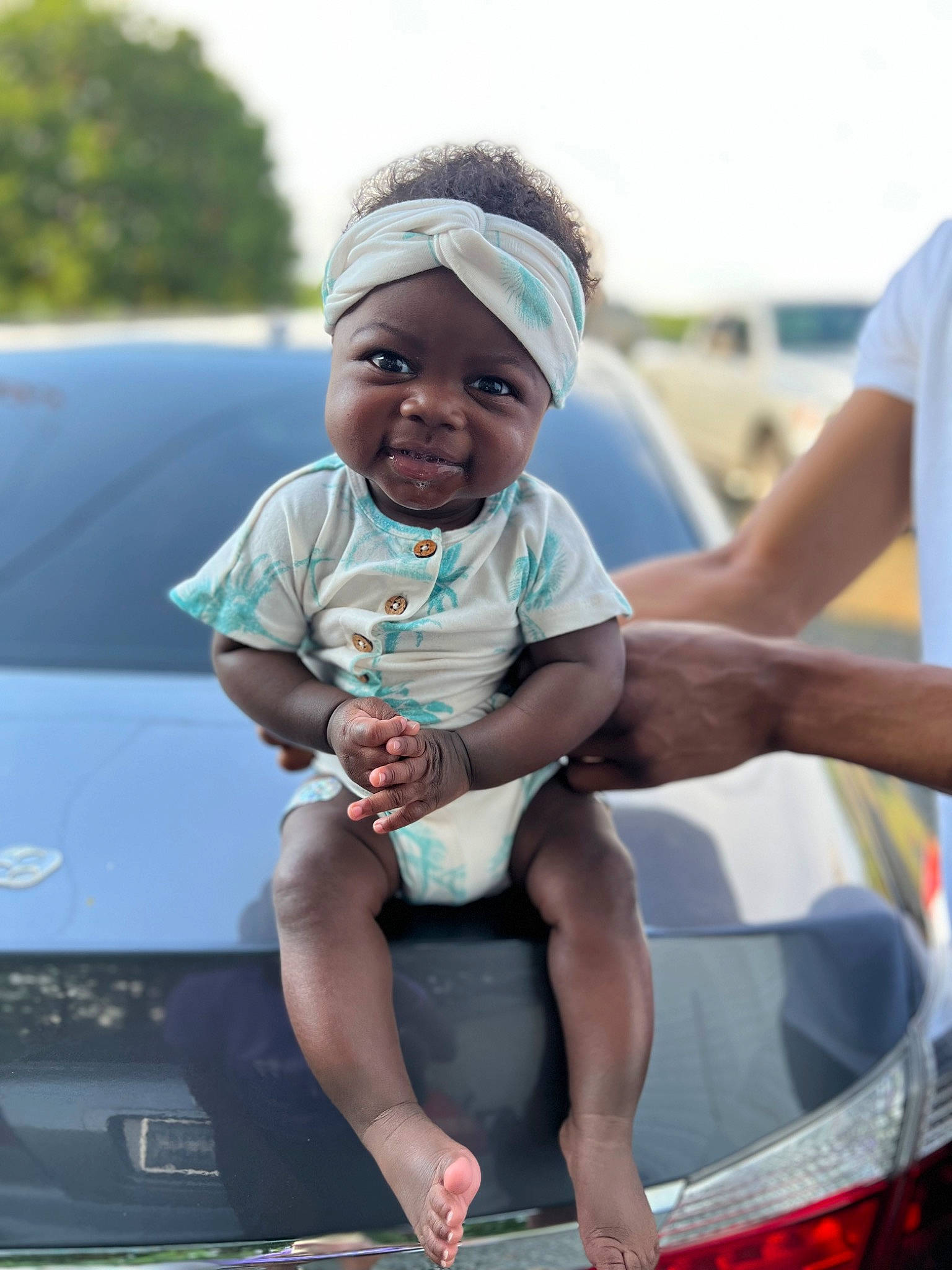 Noelani joined the competition — help win amazing prizes! automotive_design, automotive_exterior, automotive_lighting, baby, bumper, cap, car, child, electric_blue, eyewear, fun, happy, headwear, hood, leisure, motor_vehicle, person, recreation, sky, t_shirt