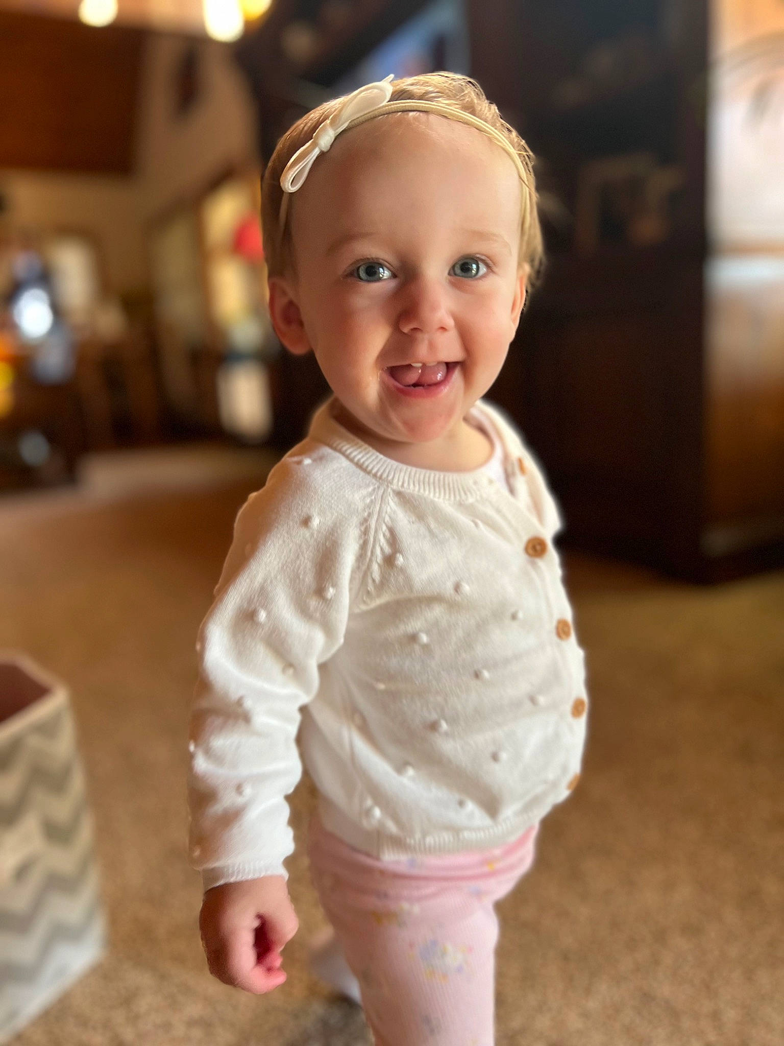 Presley is registered to the contest to win money with this photo: arm, baby, baby_toddler_clothing, cheek, dress, eye, face, flash_photography, floor, flooring, fun, happy, head, human_body, iris, joy, lip, person, skin, sleeve