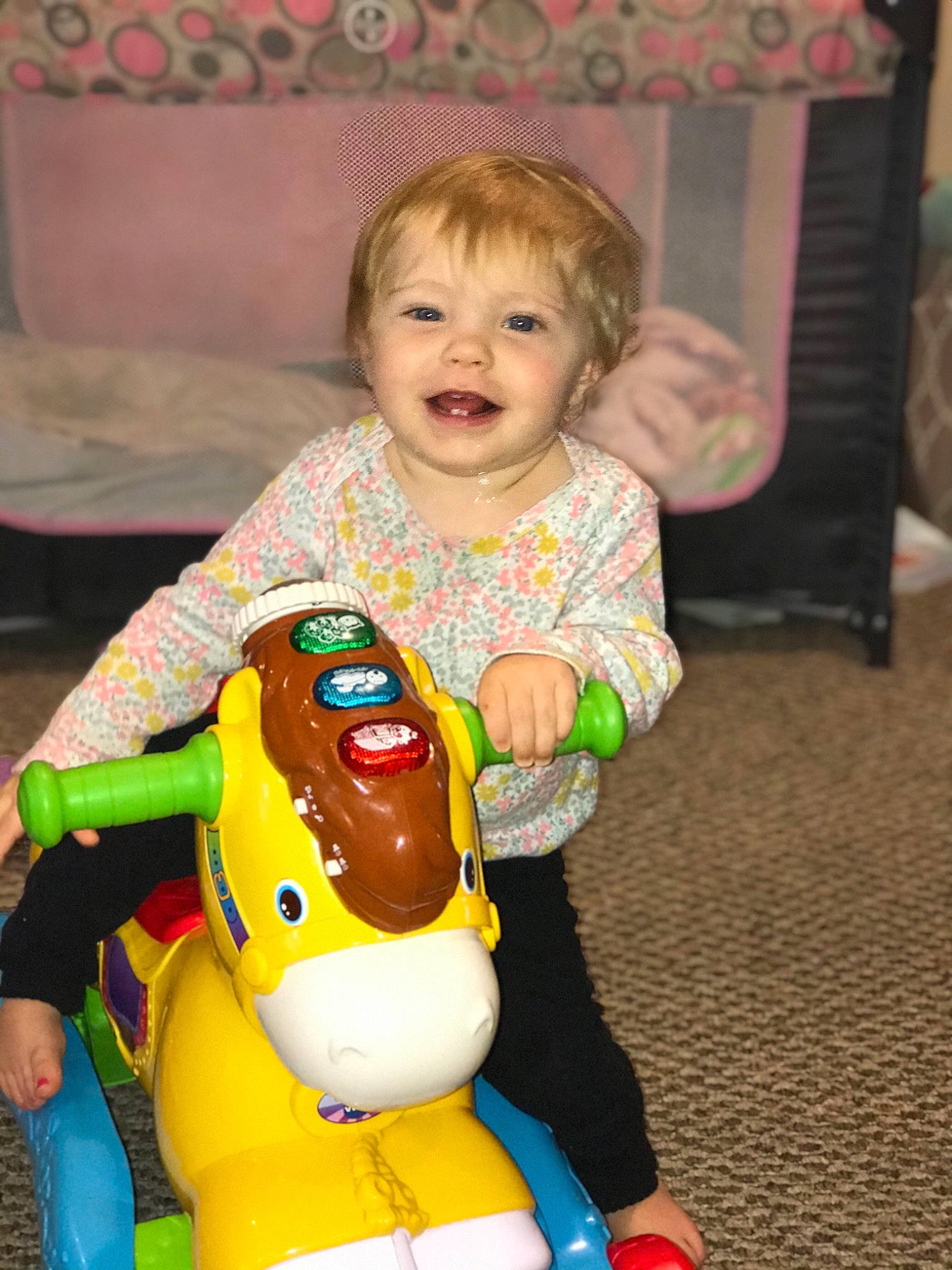 Everly is registered to the contest to win money with this photo: baby, baby_toddler_clothing, baby_toys, blond, cheek, child, eye, hand, human, human_body, lap, linens, mouth, nose, organ, person, play, riding_toy, sitting, toddler