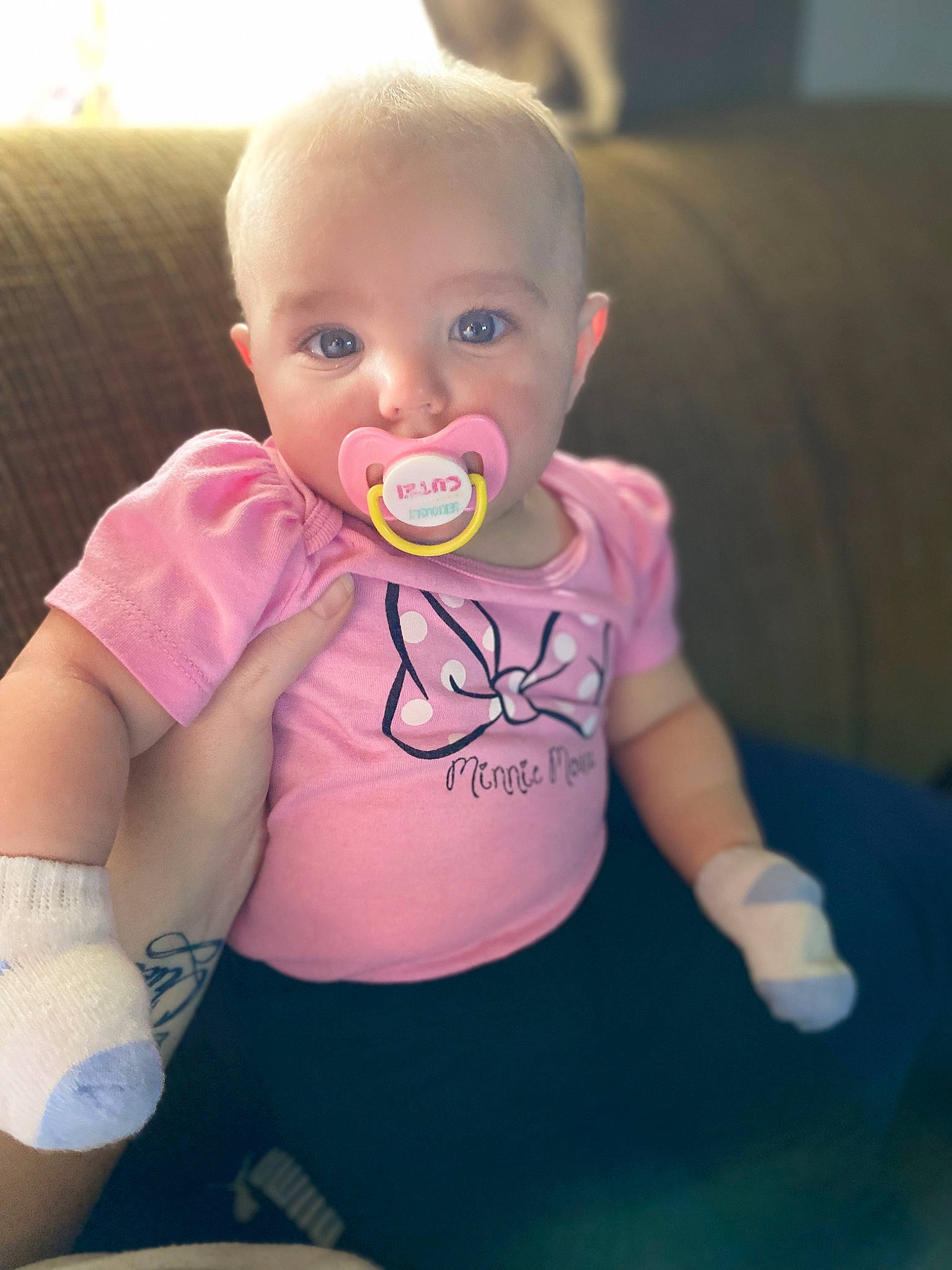 Annika is registered to the contest to win money with this photo: arm, baby, baby_toddler_clothing, cheek, comfort, eye, finger, hair, happy, head, iris, lip, mouth, neck, nose, person, skin, sleeve, t_shirt, thigh