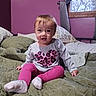 Annabelle joined the competition — help win amazing prizes! baby, child, infant, sitting, bedroom, bed, quilt, blanket, pillows, window, curtains, pink_wall, clothing, shirt, leggings, socks, leopard_print, portrait, indoors, smiling