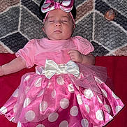 Amelia is registered to the contest to win money with this photo: baby, sleeping, pink_dress, polka_dot, bow, headband, shoes, minnie_mouse, pacifier, blanket, patterned, infant, cute, child, clothing, footwear, lying_down, indoors, soft, resting