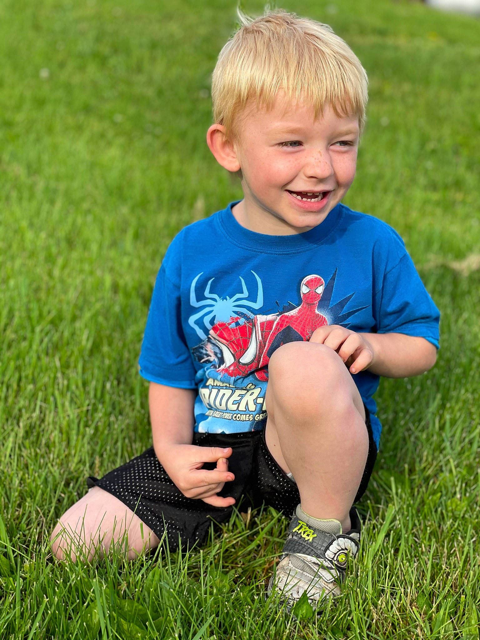 Cameran is registered to the contest to win money with this photo: baby_toddler_clothing, child, electric_blue, facial_expression, flash_photography, fun, grass, grassland, happy, joy, lawn, leisure, meadow, people_in_nature, person, plant, play, recreation, sitting, smile